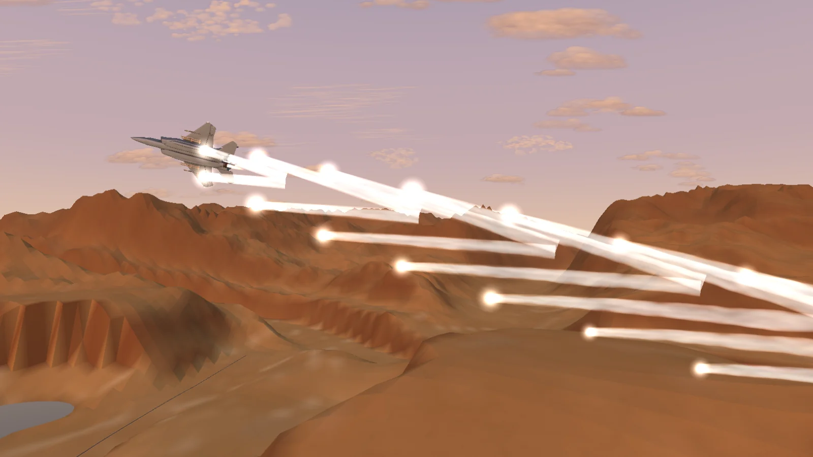An F-15E banks hard at sunset, trailing a fan of burning decoy flares.